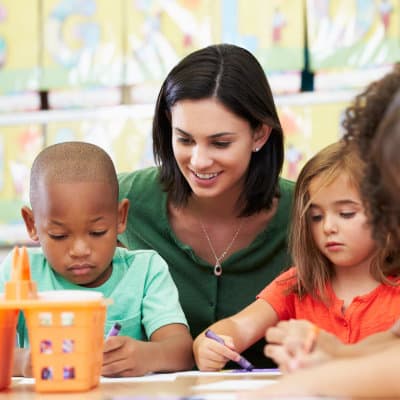 Smiling teacher with students