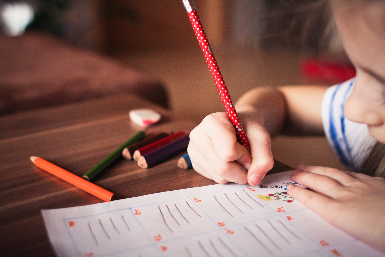 Girl Engaged in Springtime Lesson with Colored Pencils